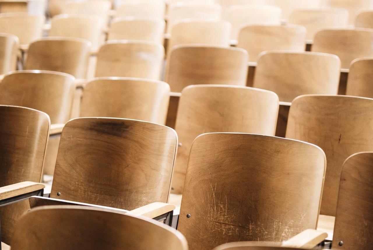 vacant brown wooden chair at stadium